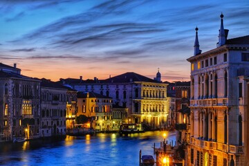 Amazing colorful sunset at the grande canal and beautiful illuminated buildings in Venice Italy
