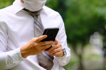Businessman using a smartphone and working on technology concept