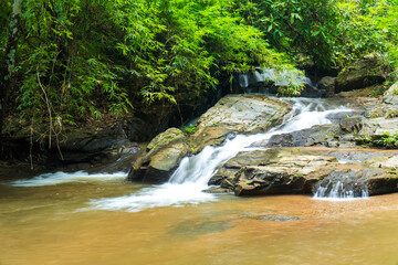 Fototapeta premium Closeup Mae Sa waterfall in Chiang Mai, Thailand. Beautiful Maesa waterfall in cool day light with green trees in Chiangmai province, Thai