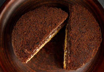 Tiramisu cake lies on a clay plate.
