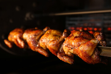 Grilling whole chickens in rotisserie machine, closeup - Powered by Adobe