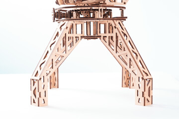 Legs of wooden toy crane on a white background