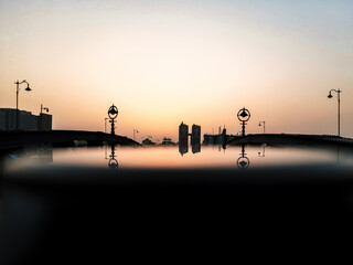 sunset in the city with reflection