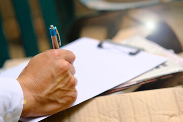 close up of a person writing on a notebook