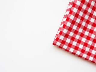 Fototapeta na wymiar Tablecloth in a red and white cage on a white background. Cloth napkins Service in a cage. Studio photo. Napkin in red and white check, texture, copy space