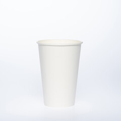 Photo of a disposable  white paper cup on a white background. Photo of a coffee cup made of recyclable materials. Empty paper coffee cup.