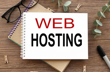 web hosting.. text on white paper on wood table background