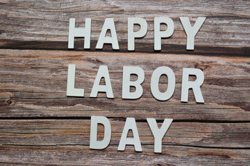 Happy labor day text on wooden table background. Labor day concept