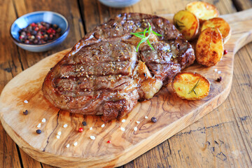 Ribeye steak on wooden board