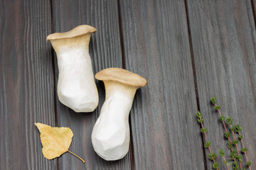 Two large mushrooms and autumn leaf.