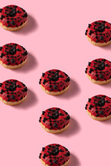 Red velvet donuts  pattern image. Many Donuts on pink vertical background.