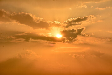 Fototapeta na wymiar the powerful sun shining through the clouds 