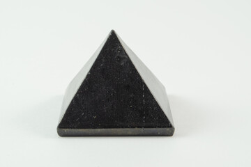 Black pyramidal mineral stone, pyramid close-up.