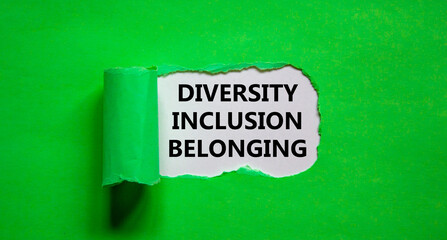 Inclusion and belonging symbol. Words 'diversity, inclusion, belonging' appearing behind torn green paper. Beautiful green background. Business, better inclusion and belonging concept. Copy space.