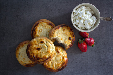 Open pies with cottage cheese close up.  Traditional Russian bakery. Freshly baked pastry items top view photo.  