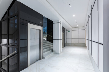Interior photography, contemporary corridor hall business center in white tiles with Marble