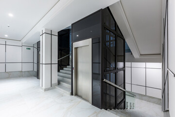 Interior photography, contemporary corridor hall business center in white tiles with Marble