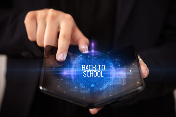 Young man holding a foldable smartphone