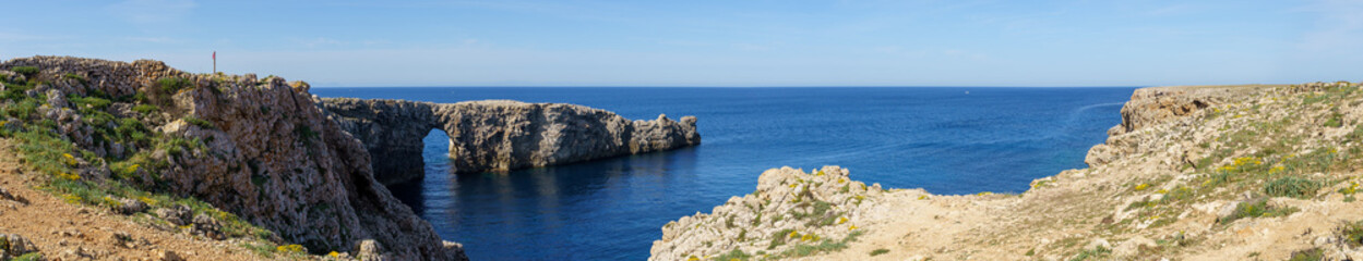 Panoramic view of Pont d'en Gil, in Menorca (Balearic Islands, Spain), in a sunny day with blue sky