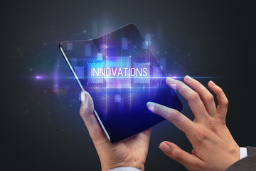 Businessman holding a foldable smartphone