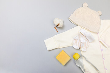 Obraz na płótnie Canvas Baby concept. Baby cloth and goods on grey background. Place for text. View from above. Flat Lay - Image