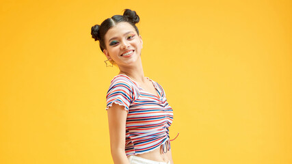 Naughty lady with bright makeup and smiles on yellow background