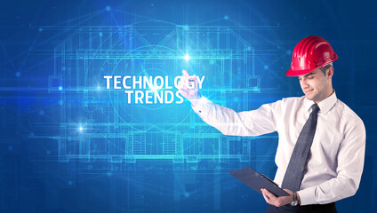 Handsome architect drawing with helmet