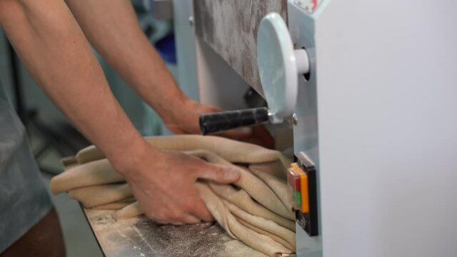 Production of dough products. The process of rolling out the dough on the dough rolling machine