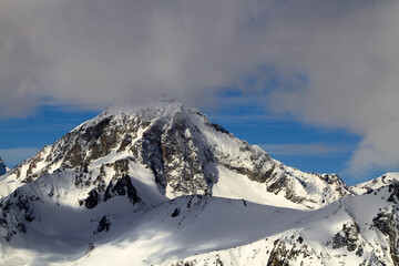 Fototapeta na wymiar Beautiful snowy mountains, blue sky and clouds Dombay Karachay-Cherkessia.