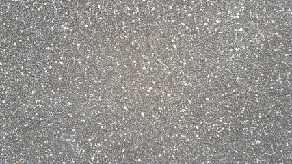 Plaster. The facade of the building with small stones. background image. Construction and architecture.