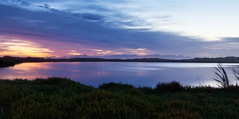 Foto op Canvas The sunrise is reflected in a lake in the False Bay Nature Reserve in Cape Town, South Africa. © Jean van der Meulen
