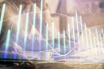 Multi exposure of man and woman working together and financial chart hologram. Business concept. Computer background.