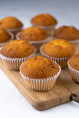 Biscuit muffins close-up. Sweet pastries. Party treat. Dessert on white table - homemade muffins. Portioned cupcakes. Simple muffin