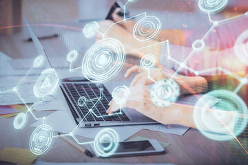 Double exposure of woman hands typing on computer and social network theme hologram drawing. People media concept.