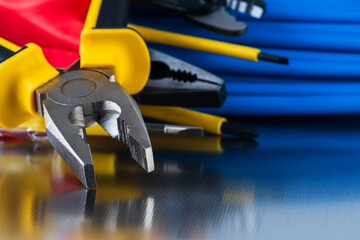 Electrical installation tool and cabling close-up shiny workshop background