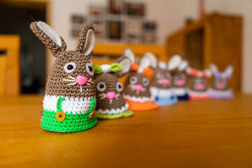Homemade Amigurumi egg warmers crocheted from wool. In different scenes with a white and gray...