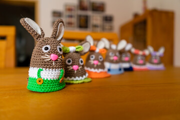 Homemade Amigurumi egg warmers crocheted from wool. In different scenes with a white and gray...