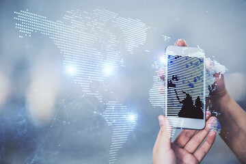 Double exposure of social network sketch hologram and woman holding and using a mobile device.