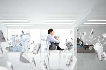 scared businessman on a chair in office