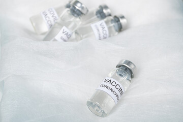 Vaccination covid-19 for immunity against disease, bottles of ampoule with coronavirus vaccine on medical white background in clinic