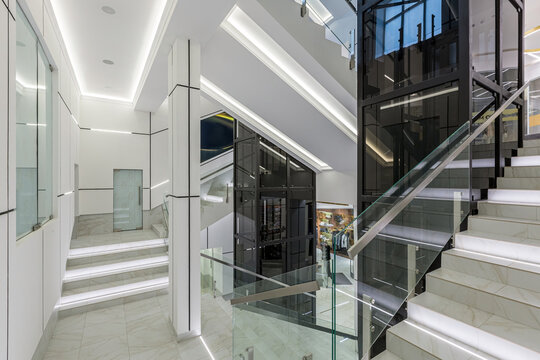 Interior photography, contemporary corridor hall business center in white tiles with Marble