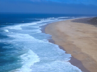 Wonderful aerial view of beach and waves at Nazare in Portugal