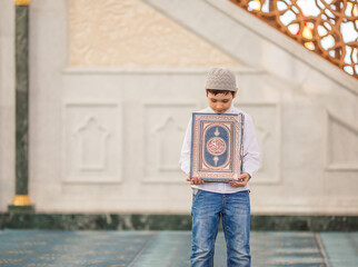 little boy in the mosque read the Quran