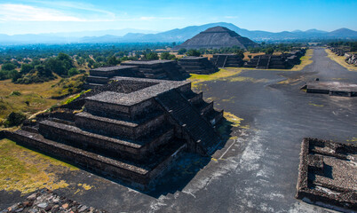 wide angle view of Mexican pyramids under bright sun 