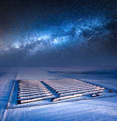 Milky way over snowy solar panels. Alternative energy in Poland