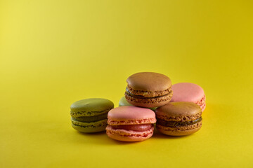 Cake macaron on yellow background flavor almond cookies pastel colors.