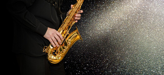 Obraz premium Musician's hands during playing saxophone