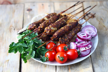 Selective focus. Kebab plate with vegetables, herbs and pita bread. Rabmadan concept. Arabic and Turkish traditional food.