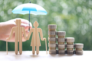 Mutual fund,Love couple senior and stack of coins money on natural green background, Save money for...