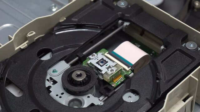 Close up Inside the CD ROM shows the operation of the system with the tray shifting and the laser reader.